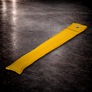 12 inch yellow marker with grommet on industrial surface long yellow fabric marker close up stitching detail
12 inch grip marker with metal grommet yellow yellow set marker large size on dark warehouse background
film production marker yellow high visibility
