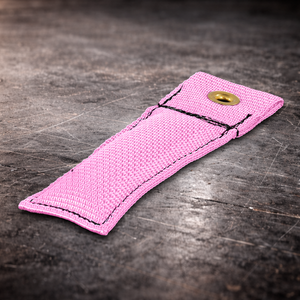 4 inch pink marker flag with grommet on industrial surface pink fabric marker close up showing stitching detail 4 inch grip marker with metal grommet for set marking pink set marker flag on dark warehouse background film production marker flag pink with grommet