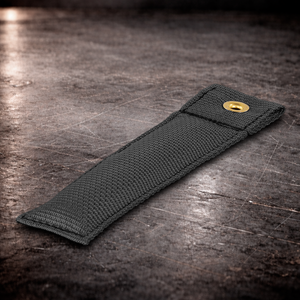 6 inch black marker with grommet on industrial surface black fabric marker close up stitching detail 6 inch grip marker with metal grommet black
black set marker on dark warehouse background film production marker black low visibility