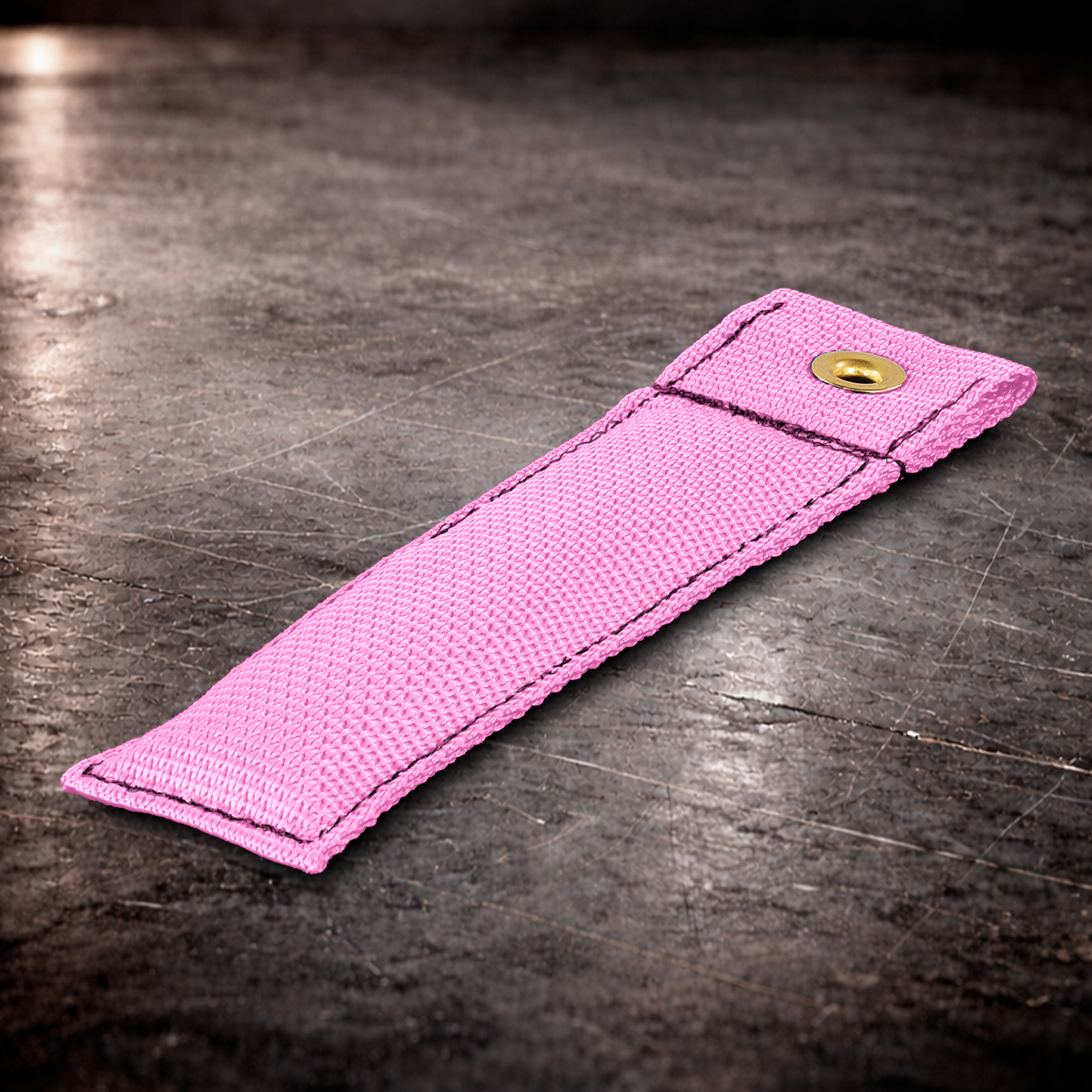 6 inch pink marker with grommet on industrial surface pink fabric marker flag close up stitching detail 6 inch grip marker with metal grommet pink pink set marker on dark warehouse background film production marker pink with grommet