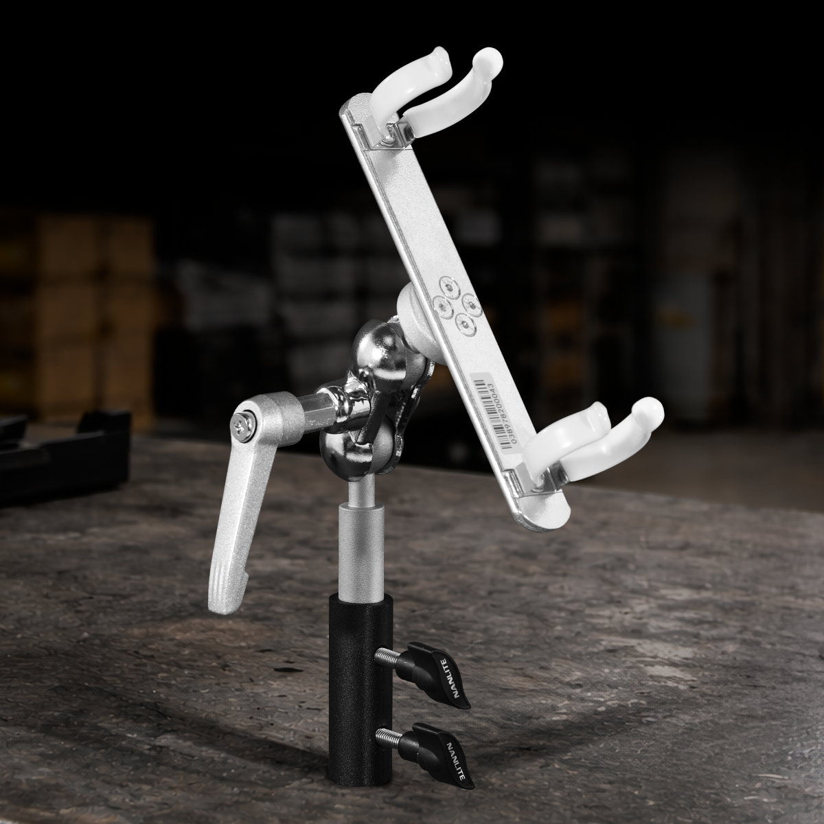 Nanlite T12 LED tube holder with adjustable ball head, swivel yoke, and integrated 5/8-inch baby pin for professional lighting setups
