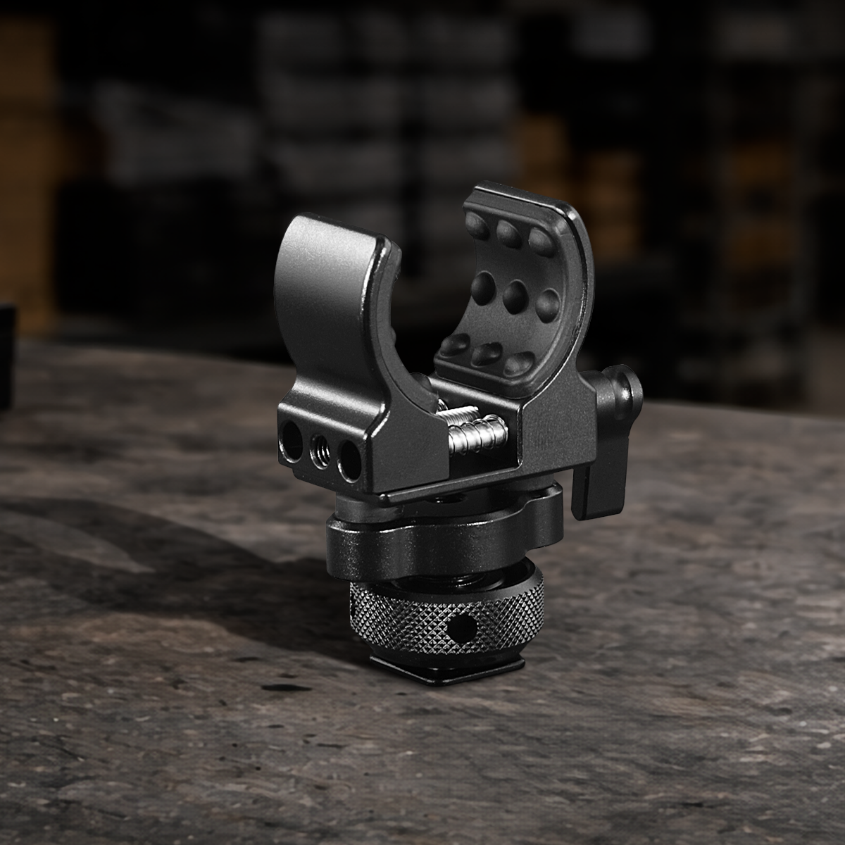 Aluminum microphone holder with 1/4"-20 mounting thread for shotgun microphones, camera rigs, cages, filmmaking, broadcasting, and professional audio production.