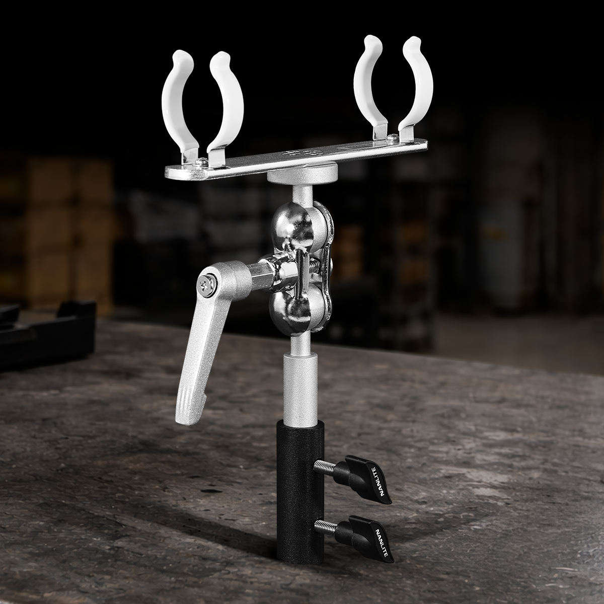 Nanlite T12 LED tube holder with adjustable ball head, swivel yoke, and integrated 5/8-inch baby pin for professional lighting setups